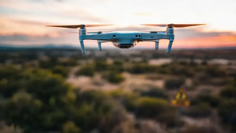 Dron sobrevolando paisaje protegido con advertencias